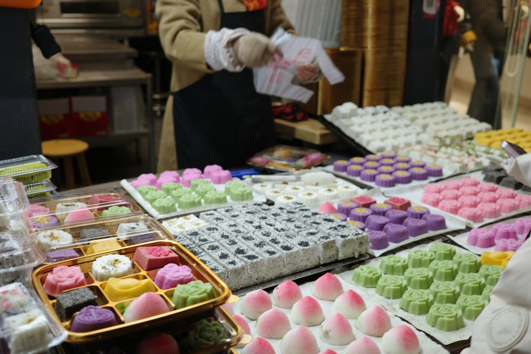 A customer selects ohagi sweets at a traditional wagashi shop near a shitamachi temple during autumn equinox week in Tokyo