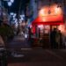 tokyo-street-shop-unsplash - TOKYOwebzine A local shopkeeper assists a customer inside a Tokyo shotengai investment property on a covered neighborhood shopping street.