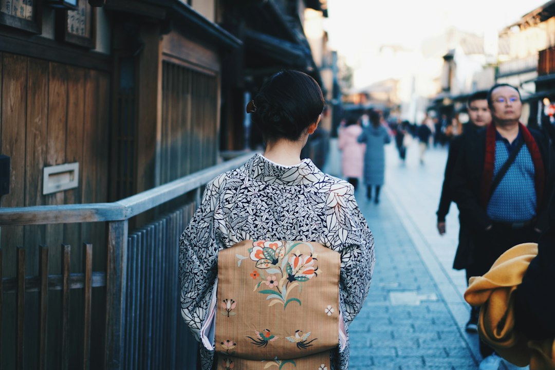 A shopper examining traditional lacquerware bowls in a craft shop on a Nikko day trip
