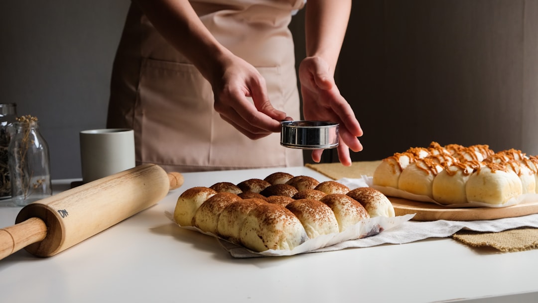 A baker slices a thick loaf of milk bread in a Tokyo bakery, showing its soft and pillowy crumb