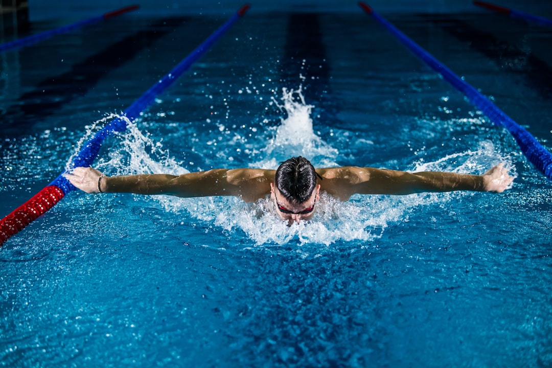 A woman swimming laps in a Tokyo public pool as part of her cold water morning routine