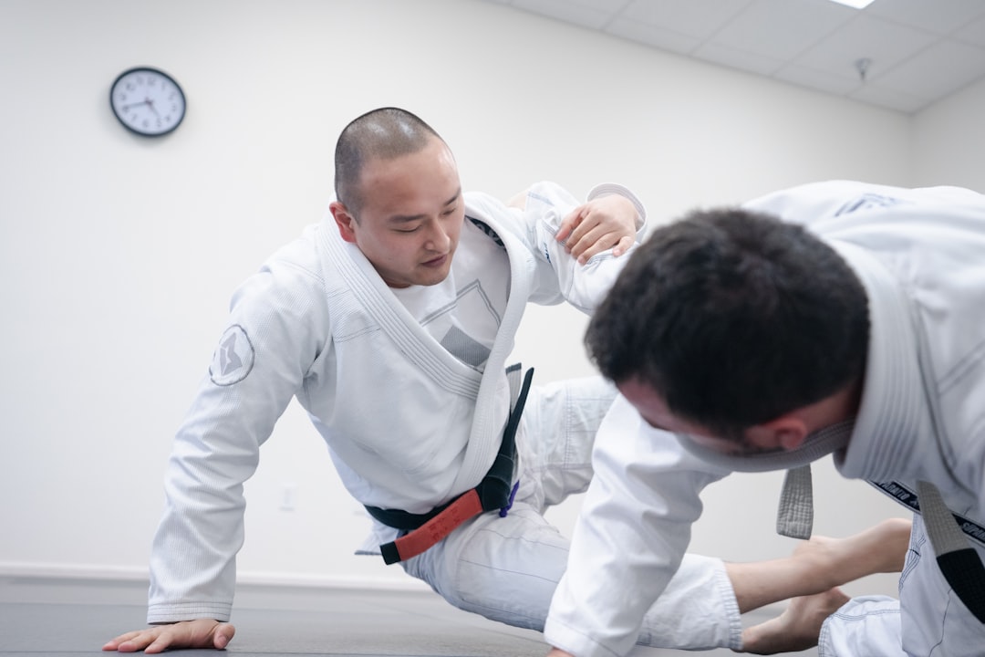 An adult beginner receives English instruction from a sensei at a Tokyo dojo during a karate class