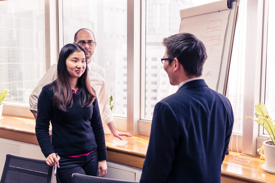 Un fondatore straniero che stringe la mano a un angel investor di Tokyo dopo un primo incontro di successo in un ufficio moderno