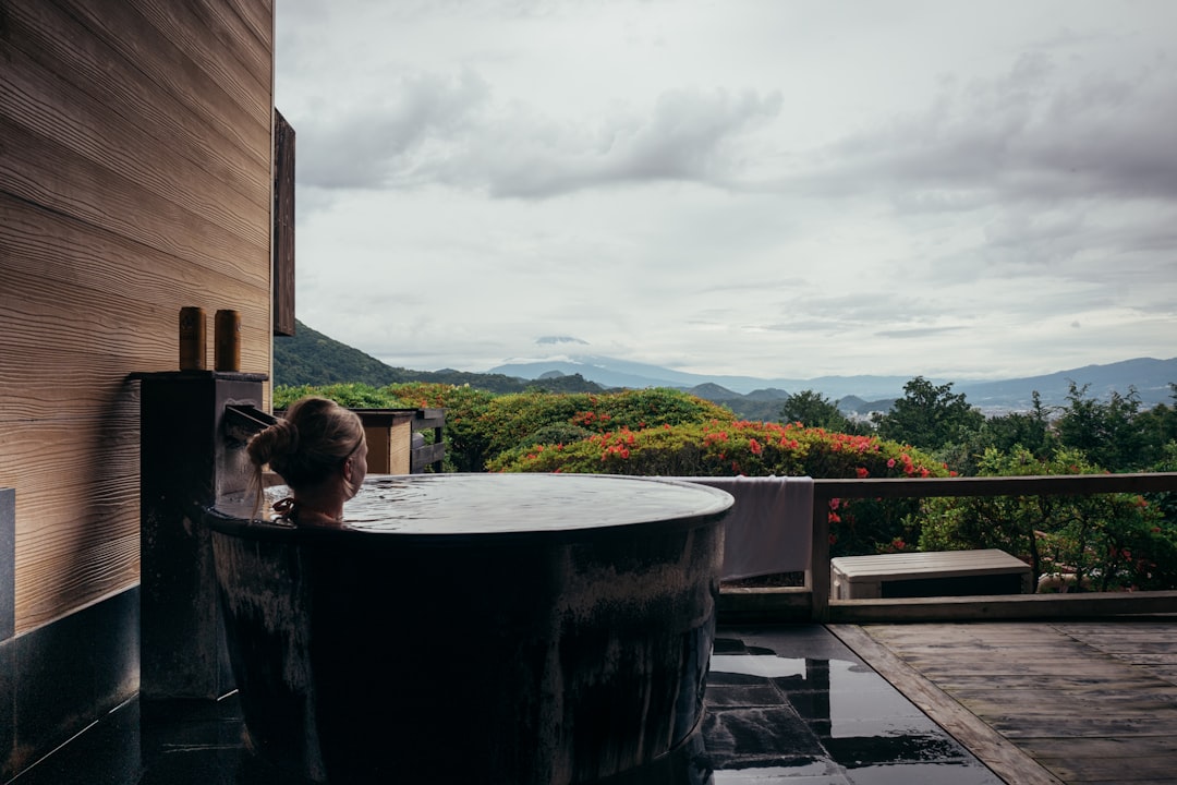 A woman resting in a private onsen suite, reflecting the serene standard of Tokyo wellness membership clubs